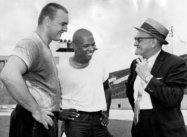 George Halas, owner-coach of the Chicago Bears (right), meets with rookies Dick Butkus (left) and Gale Sayers at an informal gathering at Soldier Field before they left for All-Star camp on July 9, 1965. Chicago Tribune