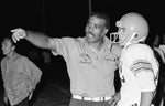 Cholla High School football coach Ed Brown, left, talks to a player during a game against Salpointe High School on Oct. 14, 1977. Courtesy P.K. Weis / Arizona Daily Star