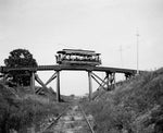 Rail car passing over the Harrison Street viaduct on the Wingra Park line, circa 1906. The line served the growing suburbs of University Heights, Oakland Heights and Wingra Park. This car had 10 bench seats running across the car and was rated as a 50-passenger car. Such cars were used extensively for transporting crowds back and forth to Forest Hill Cemetery, circus grounds, and for recreational summer rides. Courtesy Wisconsin Historical Society, Image ID 26617