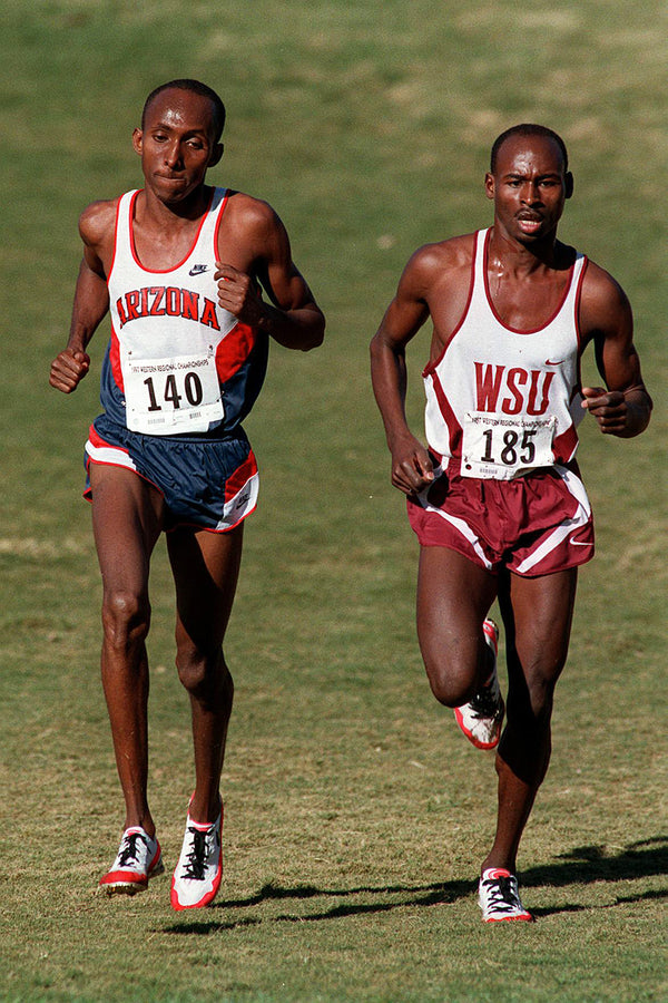 University Of Arizona runner Abdi Abdirahman dukes it out with Washington State runner Bernard Lagat in the NCAA Cross Country West Regional Championships at Dell Urich Golf Course. Bernard edged Abdi out for 2nd place in the race, Nov. 15, 1997. Courtesy James S. Wood / Arizona Daily Star