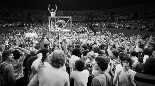 As Portland Trail Blazers fans streamed onto the court after Game 6, Dik Phillips (left) and Tom Zauner made their way to the top of the backboard and climbed their way into one of the most iconic images of the 1977 NBA championship game. Roger Jensen / The Oregonian/OregonLive