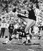 Tom Dempsey kicking a 63-yard field goal, setting the NFL record for the longest field goal kick, on the final play to defeat Detroit 19-17 on Nov. 8, 1970. AP Photo