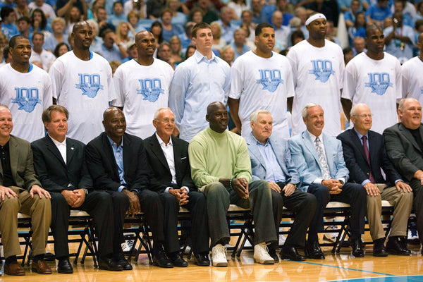 Former Tar Heel Michael Jordan sits beside his former coach Dean Smith prior to the UNC Alumni basketball game on September 4, 2009, in the Smith Center. Courtesy Robert Willett / The News & Observer