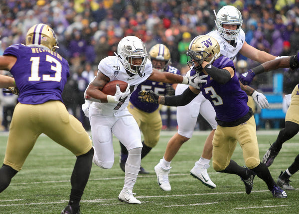 Oregon’s CJ Verdell tries to fight off Washington’s Elijah Molden as he runs up the middle. Verdell had 11 carries for 48 yards and two catches for 12 yards. Courtesy The Oregonian / Sean Meagher