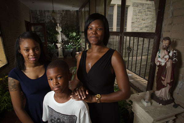 Carla Caple and daughter Aliah Caple, 19 and son Kenneth Washington, 10 at St Cyprian Church, 525 Cobbs Creek Parkway in Philadelphia on Tuesday, June 23, 2015. She has been moving from church to church and school to school because of mergers and closings. Alejandro A. Alvarez / Staff Photographer