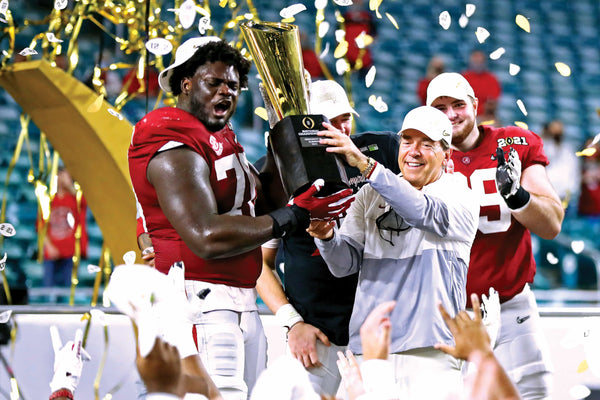 Alabama Crimson Tide head coach Nick Saban and offensive lineman Alex Leatherwood (70) celebrates with the CFP National Championship trophy after beating the Ohio State Buckeyes in the 2021 College Football Playoff National Championship Game, Jan. 11, 2021. Mark J. Rebilas / USA TODAY Sports