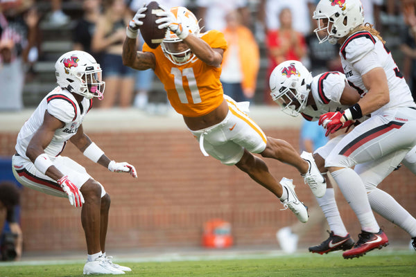Tennessee wide receiver Jalin Hyatt (11) leaps through the air for extra yardage during football game between Tennessee and Ball State at Neyland Stadium in Knoxville, Tenn. on Sept. 1, 2022. (Brianna Paciorka/News Sentinel)