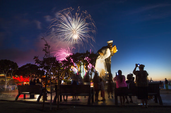 Fireworks provide a backdrop to the iconic end of World War II "Kiss" statue next to the USS Midway Museum, part of the museum's 70th anniversary of the end of World War II celebration, Aug. 15, 2015. Howard Lipin / The San Diego Union-Tribune