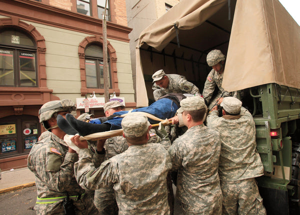 National Guard troops evacuate a woman on a stretcher. Jennifer Brown / The Star-Ledger