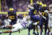 Elijah Jackson and his teammates hang on for dear life whenever Blake Corum touches the pigskin. He rushed 21 times for 134 yards with two touchdowns and a 59-yard run. JUNFU HAN/DETROIT FREE PRESS
