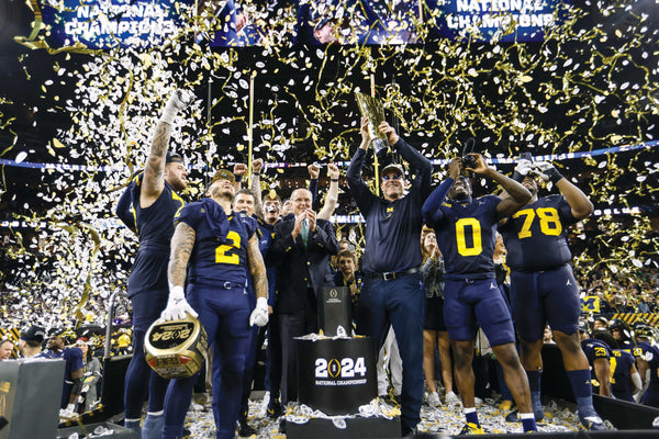 In a storm of confetti, Jim Harbaugh hoists the trophy, and his players bask in the glory of Michigan’s first national championship since 1997 and first outright championship since 1948. JUNFU HAN/DETROIT FREE PRESS