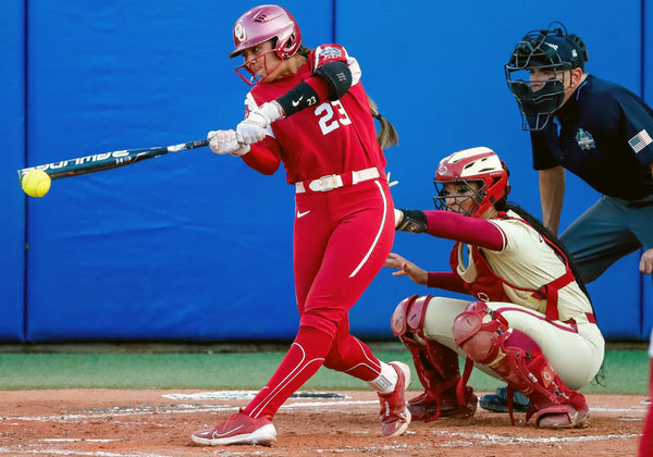 Oklahoma infielder Tiare Jennings (23) gets a base hit in the third inning during the second game of the Women’s College World Series finals against Florida State at USA Softball Hall of Fame Stadium in Oklahoma City on June 8, 2023. NATHAN J. FISH / THE OKLAHOMAN
