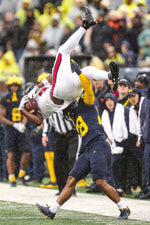 Fifth-year senior Quinten Johnson, a three-time academic All-Big Ten safety, makes sure that Omar Cooper Jr. pays the price for this catch. JUNFU HAN/DETROIT FREE PRESS