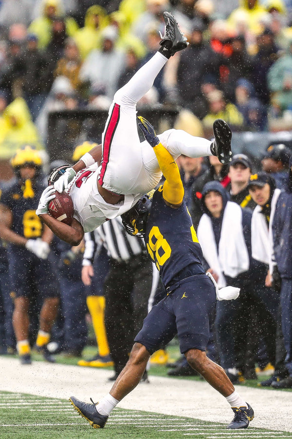 Fifth-year senior Quinten Johnson, a three-time academic All-Big Ten safety, makes sure that Omar Cooper Jr. pays the price for this catch. JUNFU HAN/DETROIT FREE PRESS