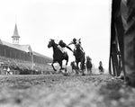 This photograph, showing the furious stretch battle between jockeys Don Meade on Brokers Tip (right) and Herb Fisher on Head Play, at the finish of the 1933 Kentucky Derby, was almost an accident. Courier-Journal photographer Wallace Lowery lay on the ground, stuck his camera under the rail and shot. This picture is the result. It is probably the most widely circulated picture in the history of the Derby. Wallace Lowery / The Courier-Journal.