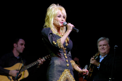 Dolly Parton singing on stage with her band