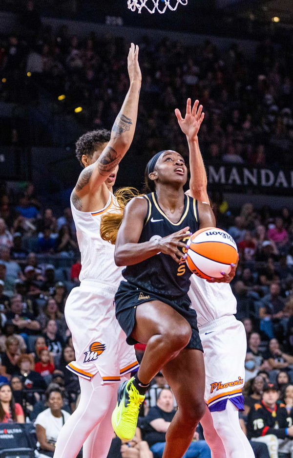 Aces guard Jackie Young (0) looks to shoot a reverse layup past Phoenix Mercury center Brittney Griner (42) during the first half of the game at the Michelob ULTRA Arena, July 11, 2023, in Las Vegas. L.E. Baskow / Las Vegas Review-Journal