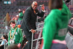 Former NBA and Charlotte 49ers star Cedric Maxwell (center) waves to a Boston Celtics fan as he walks up the stairs at Spectrum Center in Charlotte before an NBA game on Jan. 16, 2023. JEFF SINER / THE CHARLOTTE OBSERVER