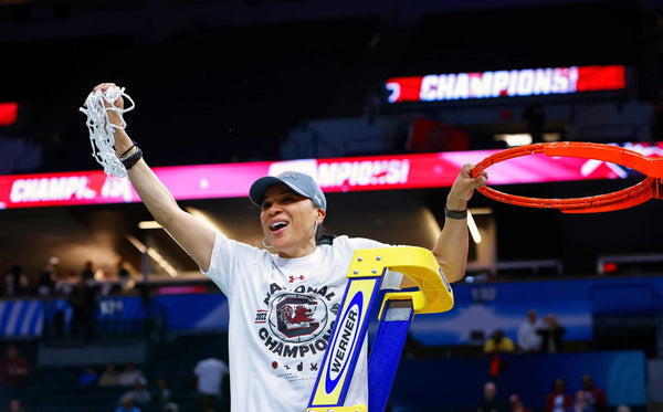 Dawn Staley celebrates with the net after her South Carolina team won the national championship against UConn in Minneapolis on April 3, 2022. It was Staley’s second national title as a coach. The first came in 2017. TRACY GLANTZ / THE STATE
