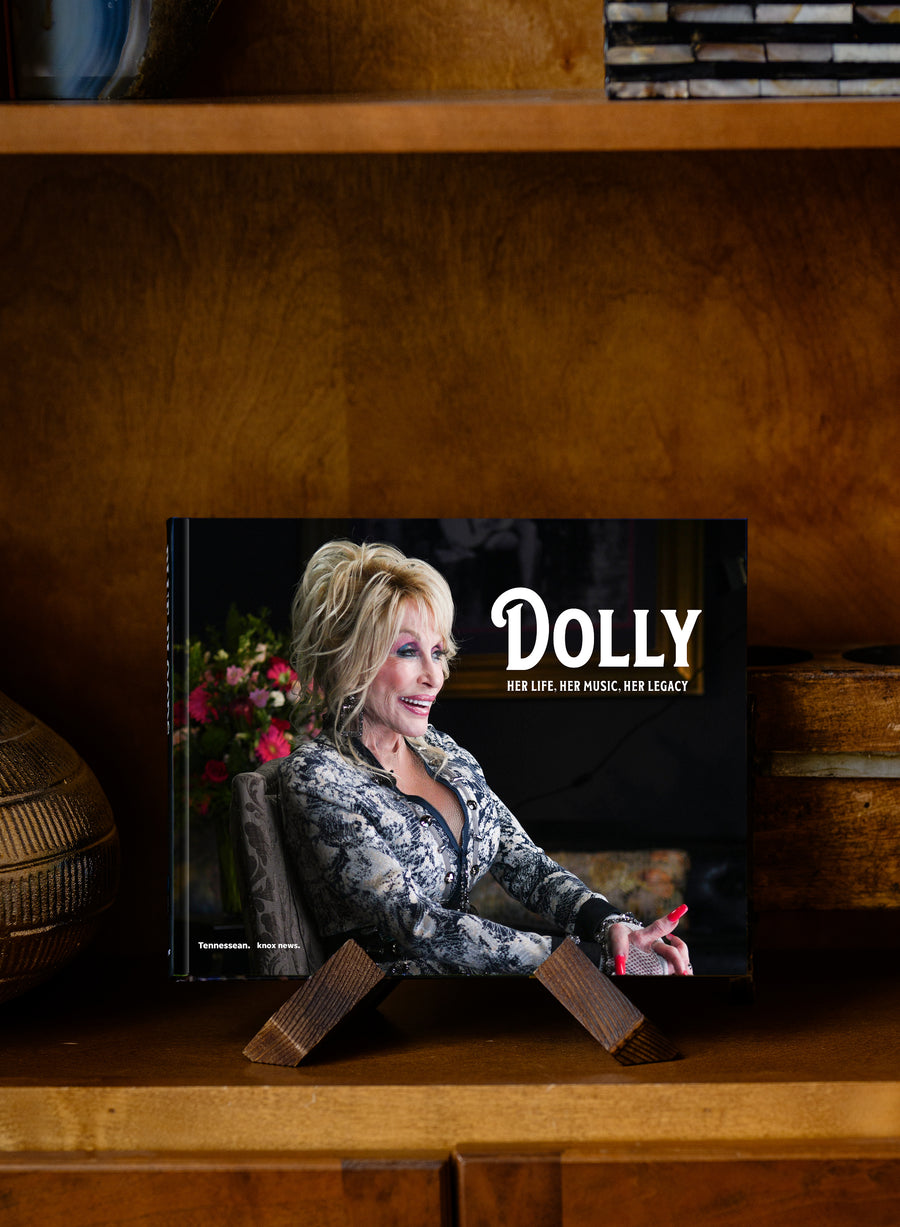 Dolly: Her Life, Her Music, Her Legacy hardcover standing on a wooden shelf
