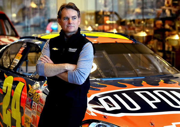 NASCAR Hall of Fame driver Jeff Gordon leans on one of his iconic No. 24 DuPont Chevrolets on March 21, 2023. Gordon, who won four NASCAR Cup season championships and retired in 2016, is now the vice chairman for Hendrick Motorsports in Concord, N.C. JEFF SINER / The Charlotte Observer