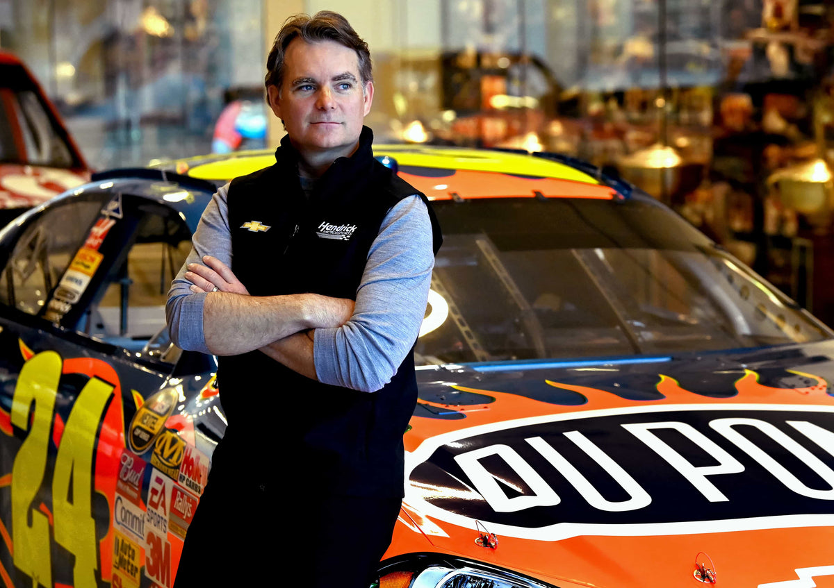 NASCAR Hall of Fame driver Jeff Gordon leans on one of his iconic No. 24 DuPont Chevrolets on March 21, 2023. Gordon, who won four NASCAR Cup season championships and retired in 2016, is now the vice chairman for Hendrick Motorsports in Concord, N.C. JEFF SINER / The Charlotte Observer