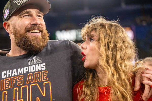 Kansas City Chiefs tight end Travis Kelce (87) and pop star Taylor Swift walk on the field after the Kansas City Chiefs defeated the Baltimore Ravens 17-10 in the AFC Championship Game at M&T Bank Stadium on Sunday, Jan. 28, 2024, in Baltimore. Courtesy Emily Curiel / The Kansas City Star