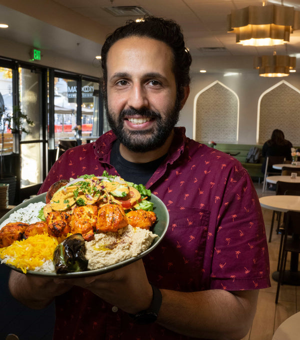 Idean Farid, owner and Executive Chef of A Taste of Maydoon restaurant, holds a plate of chicken kebabs. HECTOR AMEZCUA / THE SACRAMENTO BEE