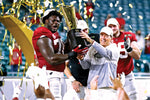 Alabama Crimson Tide head coach Nick Saban and offensive lineman Alex Leatherwood (70) celebrates with the CFP National Championship trophy after beating the Ohio State Buckeyes in the 2021 College Football Playoff National Championship Game, Jan. 11, 2021. Mark J. Rebilas / USA TODAY Sports
