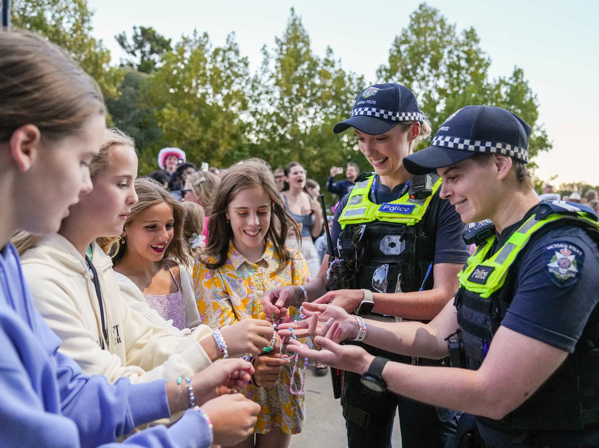 Leading Senior Constable Alison Noonan (left) and Bec Noviello with the Victoria Police Department
exchange friendship bracelets with Taylor Swift fans outside Melbourne Cricket Grounds on Feb. 18, 2024,
in Melbourne, Australia. Bryan West / USA TODAY NETWORK