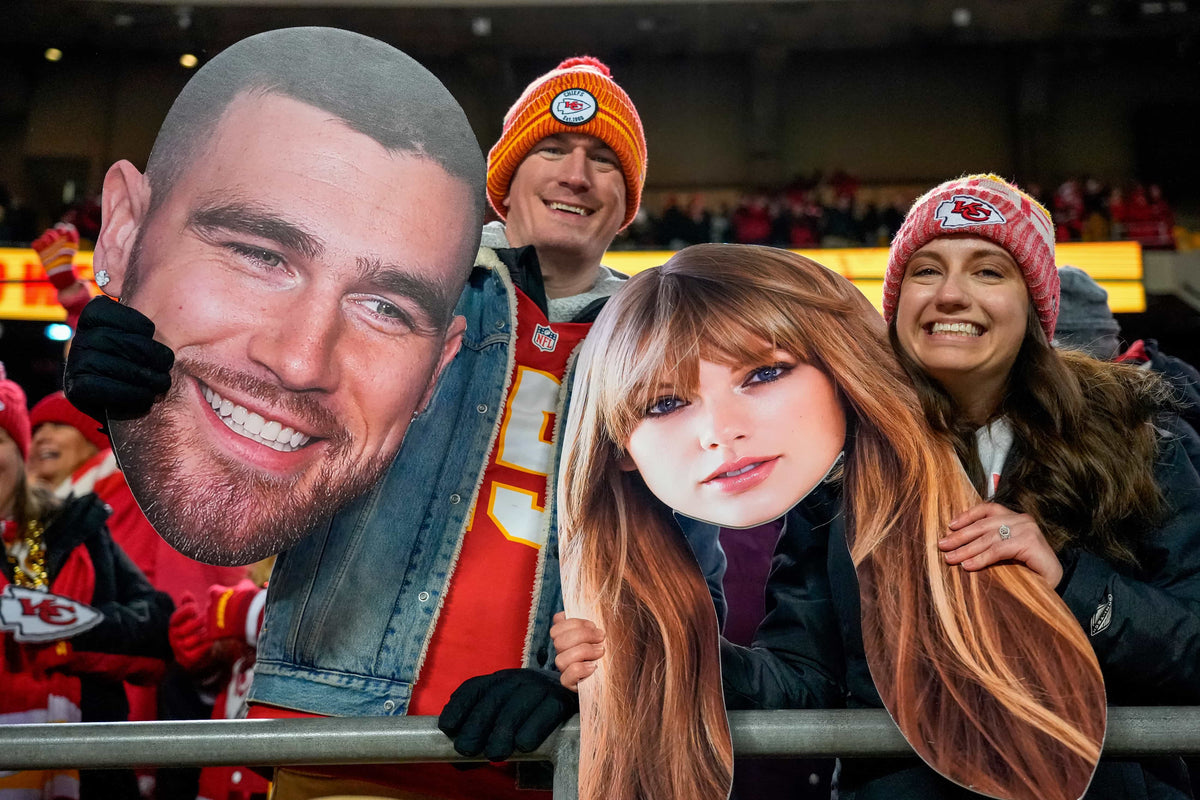 Fans wave big heads of Travis Kelce and Taylor Swift during the Kansas City Chiefs game against the Cincinnati Bengals at Arrowhead Stadium on Dec. 31, 2023.Sam Greene / USA TODAY NETWORK
