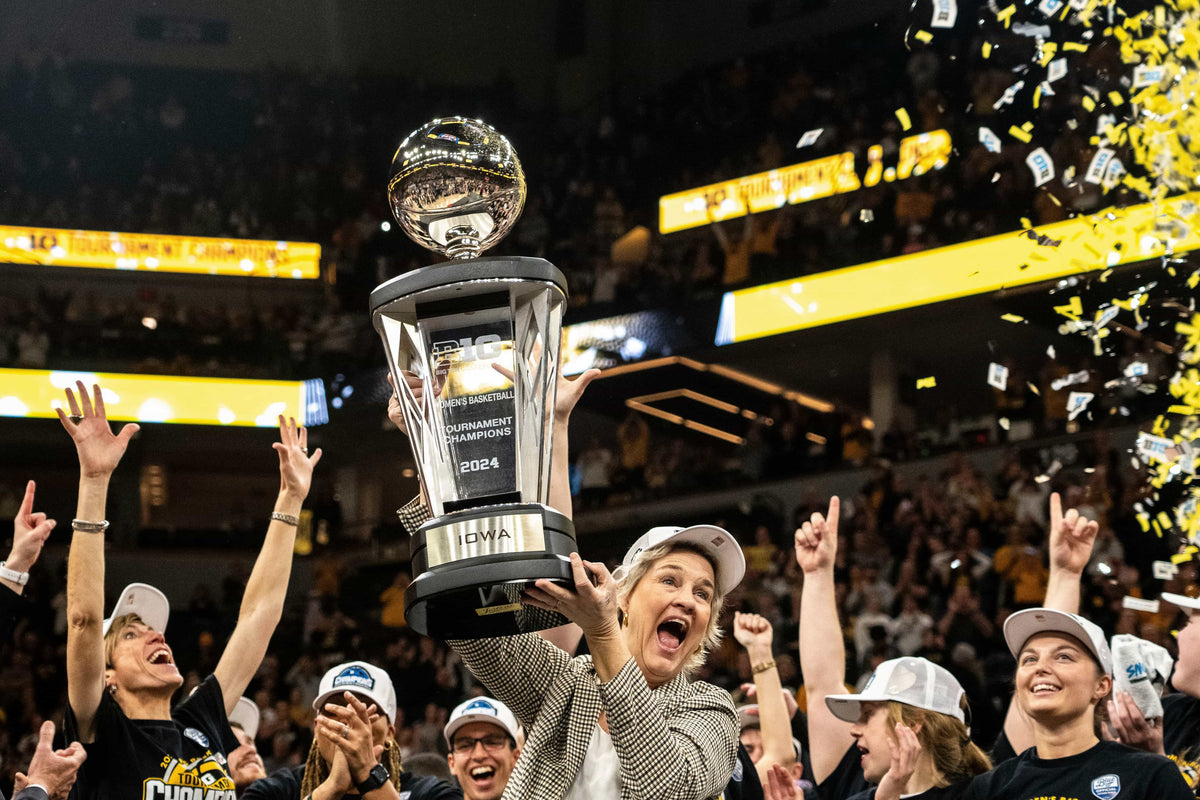 Iowa head coach Lisa Bluder holds the Big Ten Tournament champion trophy after the Big Ten Tournament championship game at the Target Center on March 10, 2024. Lily Smith / Des Moines Register
