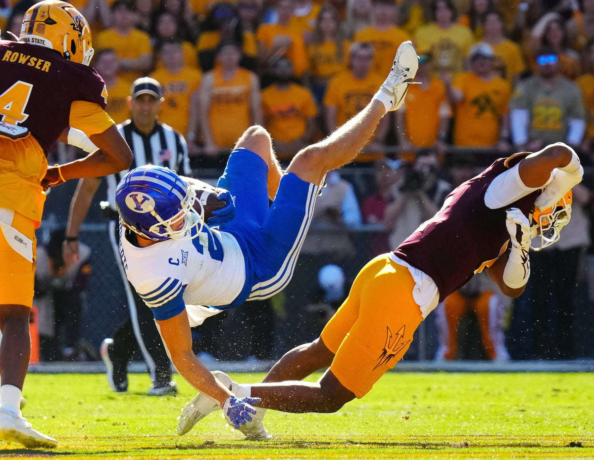 Defensive back Xavion Alford upends BYU receiver Chase Roberts during the Sun Devils’ emotional victory over the Cougars. Alford made 85 tackles for the season, second on the team behind Myles (Ghost) Rowser’s 98.  Patrick Breen / The Republic