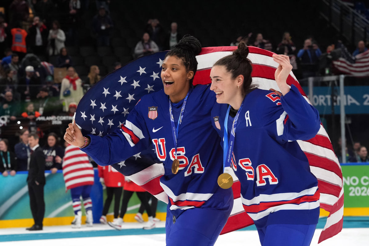Laila Edwards (10) of the United States and Megan Keller (5) of the United States celebrate after winning the gold medal in women's ice hockey after defeating Canada during the Milano Cortina 2026 Olympic Winter Games at Milano Santagiulia Ice Hockey Arena. Amber Searls / Imagn Images