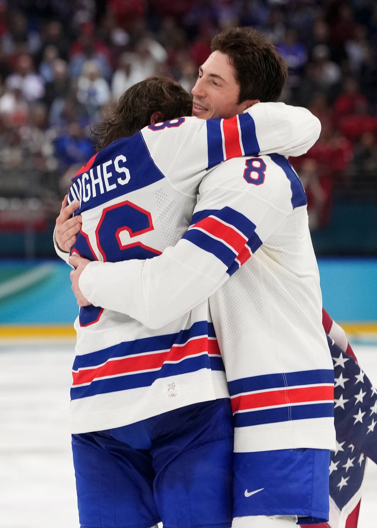 Jack Hughes (86) of the United States celebrates with Zach Werenski (8) of the United States after defeating Canada in the men's ice hockey gold medal game during the Milano Cortina 2026 Olympic Winter Games at Milano Santagiulia Ice Hockey Arena. Amber Searls / Imagn Images