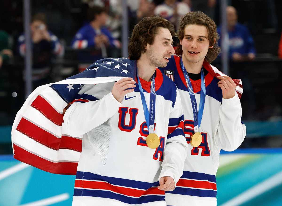 Quinn Hughes (43) of the United States and Jack Hughes (86) of the United States celebrate after defeating Canada in the men's ice hockey gold medal game during the Milano Cortina 2026 Olympic Winter Games at Milano Santagiulia Ice Hockey Arena. Geoff Burke / Imagn Images
