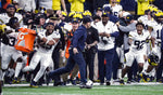 A scrambler from his playing days, Jim Harbaugh manages to elude a Gatorade bath. “Incredible feeling,” he said of U-M’s victory. “What our team planned for, hoped for, worked for.” With skill and luck, the players would get two more shots to douse him. KIRTHMON F. DOZIER/DETROIT FREE PRESS