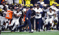 A scrambler from his playing days, Jim Harbaugh manages to elude a Gatorade bath. “Incredible feeling,” he said of U-M’s victory. “What our team planned for, hoped for, worked for.” With skill and luck, the players would get two more shots to douse him. KIRTHMON F. DOZIER/DETROIT FREE PRESS