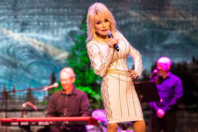 Dolly Parton performing in a white dress