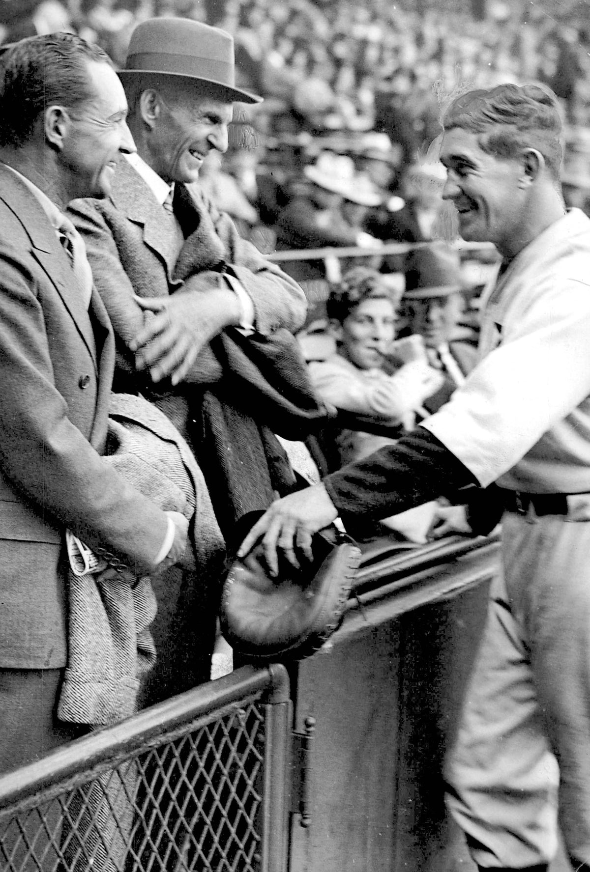 Edsel Ford with his father Henry Ford talk with Tiger catcher and manager Mickey Cochrane at Navin Field in Detroit in September 1934. Detroit Free Press archives