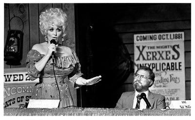 A young Dolly Parton at the microphone in an early archival photo