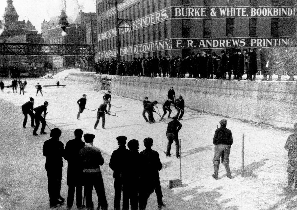 In 1903 the Erie Canal lay where Broad Street is today. Boys played hockey on it, and the Aqueduct Building (right background) at the west end bore the names of two companies that became parts of Lawyers Co-operative Publishing Co. Rochester Times-Union