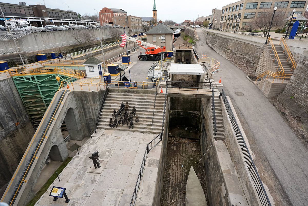 A public art installation, the Lock Tenders Tribute, sits next to the old Flight of Five Locks, and what was once the former towpath in Lockport in 2025. The historical parts of the Erie Canal were preserved and are to the right of the current lock system. Tina MacIntyre-Yee / Democrat and Chronicle