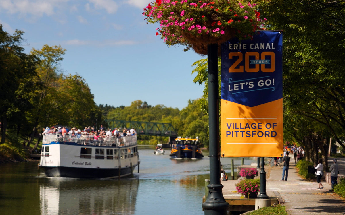 The Colonial Belle followed by the Thomas X. Grasso boat begins the flotilla as it escorts the Buffalo Maritime Center’s replica of the Seneca Chief from Pittsford to Fairport in 2025. Kelci Sherman / Syracuse University