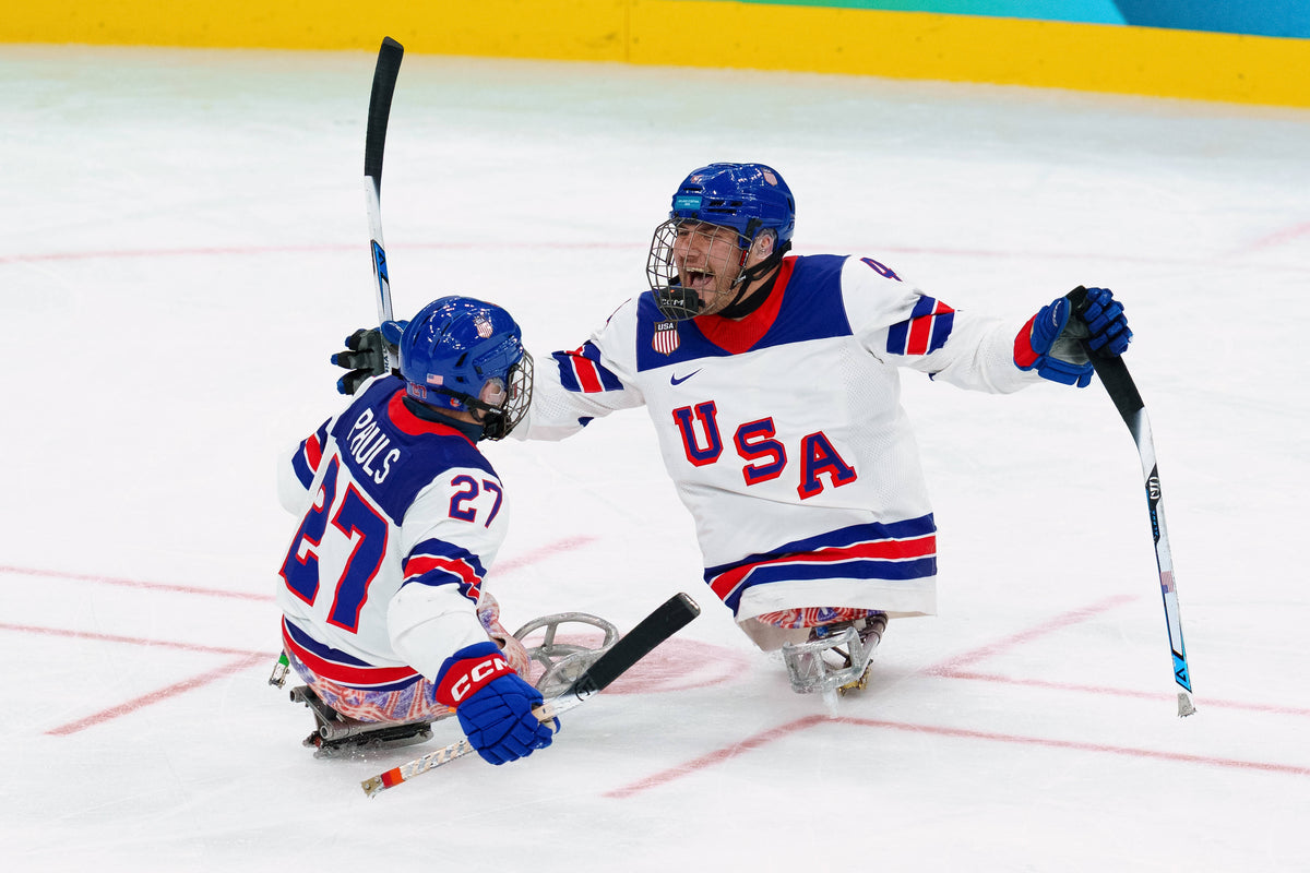 Team USA’s Brody Roybal (4) and Josh Pauls (27) celebrate a goal during the gold medal match against Team Canada during the Milano-Cortina 2026 Paralympic Winter Games at Milano Santagiulia Ice Hockey Arena on March 15, 2026. Elliot Walker / USA TODAY Network