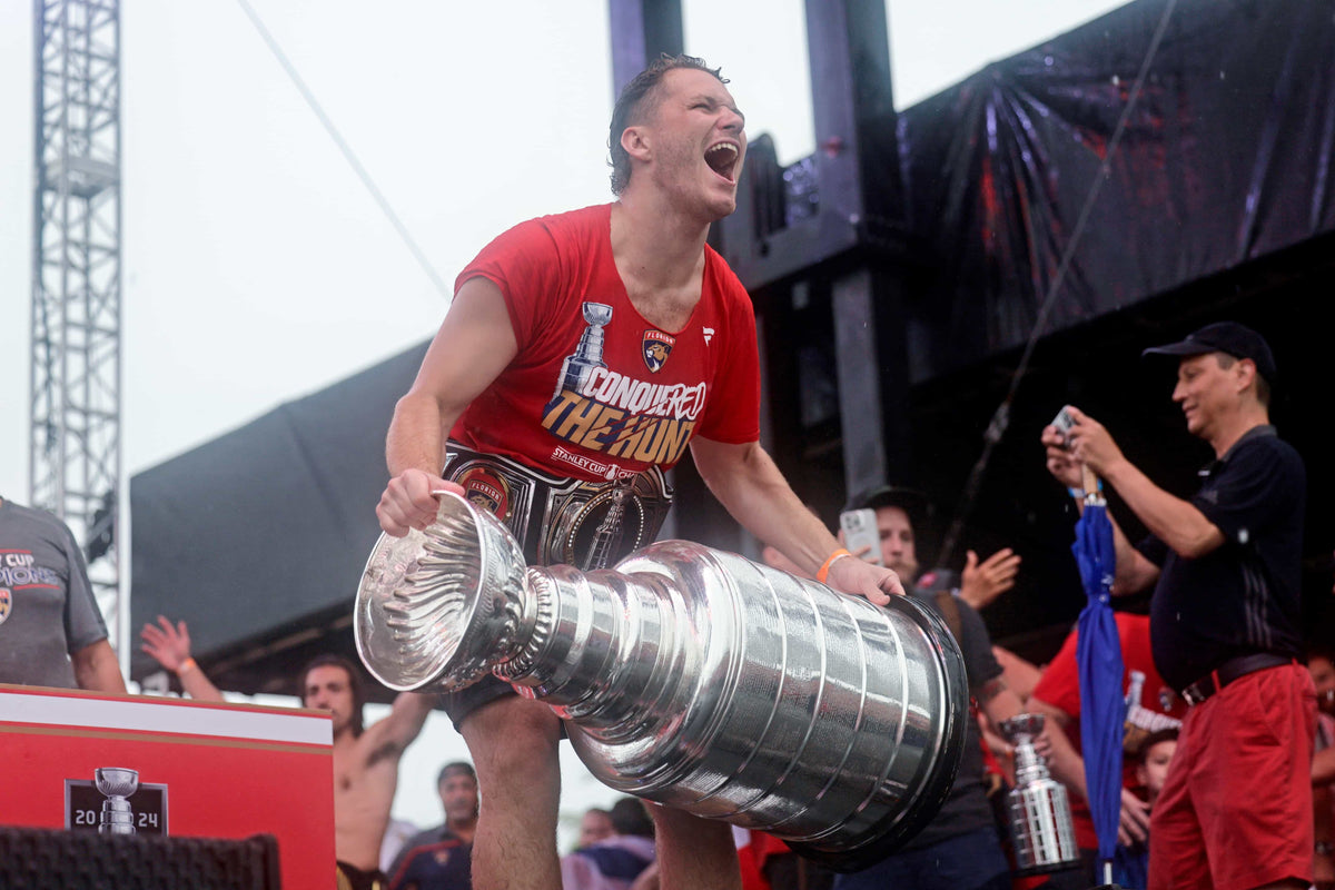 Florida Panthers left wing Matthew Tkachuk holds the Stanley Cup on stage during the team’s Championship Celebration on June 30, 2024, at Fort Lauderdale Beach.