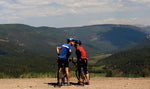 Two cyclists take a romantic break at a scenic view on the side of Highway 17 during day four of tour from Chama, N.M., to Alamosa.