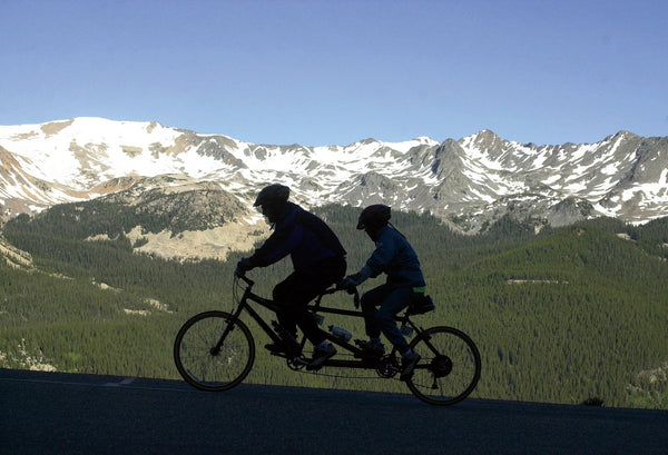 Two cyclists on a tandem bicycle climb toward the Timber Lake Trailhead during the trip from Granby to Estes Park.  Hyoung Chang, The Denver Post