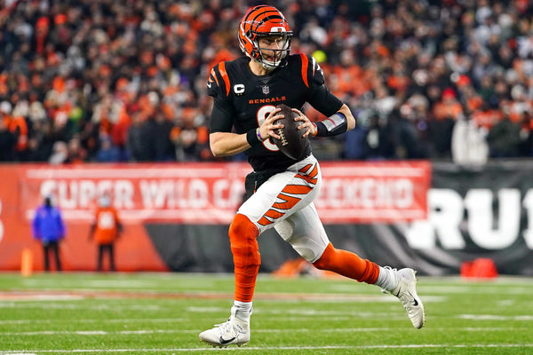 Cincinnati Bengals quarterback Joe Burrow (9) runs out of the pocket in the second quarter during an NFL AFC wild-card playoff game against the Las Vegas Raiders, Saturday, Jan. 15, 2022, at Paul Brown Stadium in Cincinnati. Kareem Elgazzar/The Enquirer