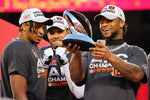Cincinnati Bengals wide receiver Ja'Marr Chase (1), wide receiver Tyler Boyd (83) and running back Joe Mixon (28) admire the AFC Championship trophy at the conclusion of the AFC championship NFL football game, Jan. 30, 2022, at GEHA Field at Arrowhead Stadium in Kansas City, Mo. The Cincinnati Bengals defeated the Kansas City Chiefs, 27-24, to advance to the Super Bowl. Sam Greene/The Enquirer